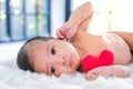 2-month-old babies lie on the white cloth and the morning sun