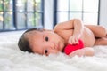 2-month-old babies lie on the white cloth and morning sun shines