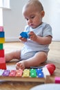 8 Month Old Baby Boy Learning Through Playing With Coloured Wooden Blocks At Home Royalty Free Stock Photo