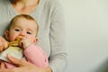 5 month old baby eating a chicken leg using the Baby led weaning BLW method Royalty Free Stock Photo