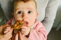 5 month old baby eating a chicken leg using the Baby led weaning BLW method Royalty Free Stock Photo