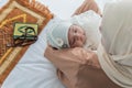 1-month-old baby newborn girl, is half Thai-half Nigerian. sleeping and happy while her mother holding Royalty Free Stock Photo