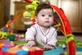 6 month old cute baby girl playing with toy piano on a play mat Royalty Free Stock Photo