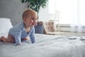 8 month old happy baby boy crawling on bed at home Royalty Free Stock Photo