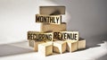 Monthly Recurring Income MRR text on wood blocks.