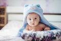 3 months baby boy weared in funny hat lying down on a blanket. A portrait of a cute blond baby