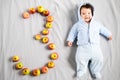 3 months baby. Portrait of an adorable 3 month old baby in the bedroom on the bed in white clothes