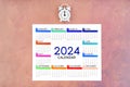 12 months desk calendar 2024 and alarm clock on old Royalty Free Stock Photo
