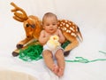 4 months old baby boy playing with soft toy dear and chick Royalty Free Stock Photo