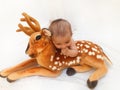 4 months old baby boy playing with soft toy dear and chick Royalty Free Stock Photo