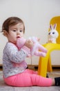 10 months old baby girl playing with toys. Portrait of a cute little girl Royalty Free Stock Photo