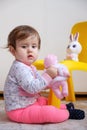 10 months old baby girl playing with toys. Portrait of a cute little girl Royalty Free Stock Photo