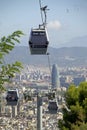 MontjuÃÂ¯c cable car and view of Barcelona with Torre GlÃÂ²ries