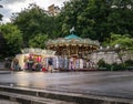 Montmartre carousel on plaza at dusk after rain