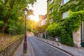 Montmartre district of Paris. Houses on narrow road in Montmartre district of Paris. View of cozy street in quarter Montmartre in Royalty Free Stock Photo