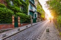 Montmartre district of Paris. Houses on narrow road in Montmartre district of Paris. View of cozy street in quarter Montmartre in Royalty Free Stock Photo