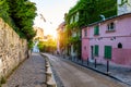 Montmartre district of Paris. Houses on narrow road in Montmartre district of Paris. View of cozy street in quarter Montmartre in Royalty Free Stock Photo