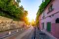 Montmartre district of Paris. Houses on narrow road in Montmartre district of Paris. View of cozy street in quarter Montmartre in Royalty Free Stock Photo