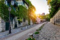 Montmartre district of Paris. Houses on narrow road in Montmartre district of Paris. View of cozy street in quarter Montmartre in Royalty Free Stock Photo