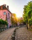 Montmartre district of Paris. Houses on narrow road in Montmartre district of Paris. View of cozy street in quarter Montmartre in Royalty Free Stock Photo