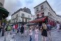 A wide angle landscape view of tourists enjoying the artistic cobblestone streets of Royalty Free Stock Photo