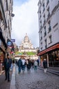 Montmartre shopping district and Sacre Coeur cathedral with tourists