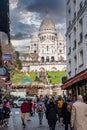 Montmartre shopping district and Sacre Coeur cathedral with tourists