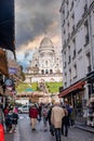 Montmartre shopping district and Sacre Coeur cathedral with tourists