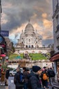 Montmartre shopping district and Sacre Coeur cathedral with tourists