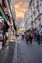 Montmartre shopping district and Sacre Coeur cathedral with tourists