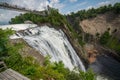 Cloudy summer day with insane view of beautiful and powerful Montmorency waterfall with a zipline passing above it