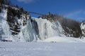 Montmorency waterfall with rainbow with snow in winter