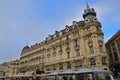 A historic building with market stall umbrellas at Place de la Comedie square in Montpellier, Herault in Southern France