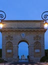 Night view on Triumphal arch Porte du Peyrou in historical quarter of Montpellier. The arch was built in 1693. The reliefs show