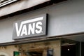 Vans logo brand and text sign front of clothes fashion store of american footwear Royalty Free Stock Photo