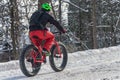 A man is riding a fat tire snow bike in the Mont Royal Park