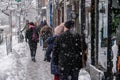 Pedestrians walking on Mont-Royal Avenue during snow storm Royalty Free Stock Photo