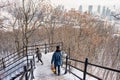 People going down the wide wooden staircase in the Mont Royal Park in winter