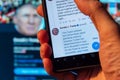 Smartphone showing Twitter covering Trump tweet with warning label for Ã¢â¬Åglorifying violence