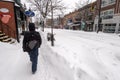 Pedestrian walking on Mont-Royal Avenue during snow storm Royalty Free Stock Photo