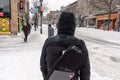 Pedestrian walking on Mont-Royal Avenue during snow storm Royalty Free Stock Photo