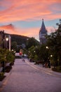 Beautiful moody sunset scene at Mctavish street. People walking on cobblestone, mout royal and the tower of Mcgill university Royalty Free Stock Photo