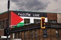 Palestine flag and free palestine palestine libre slogan painted on the brick walls of a building in Montreal, Canada Royalty Free Stock Photo