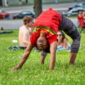 Young and elastic Afro American female is making a back bridge strech move