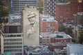 Montreal city skyline view from Mount Royal featuring Leonard Cohen mural on a sunny summer afternoon in Quebec, Canada