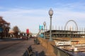 Montreal embankment - old lanterns, benches, ferris wheel, people walking along the embankment, leisurely rhythm of life, tourism