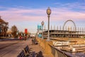 Montreal embankment - old lanterns, benches, ferris wheel, people walking along the embankment, leisurely rhythm of life, tourism