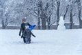 Mother  and child walking in Jeanne-Mance park during snowstorm Royalty Free Stock Photo