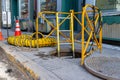 Manhole opened with ladder going down and safety rails Royalty Free Stock Photo