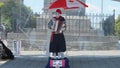 A mime street performer playing an accordion